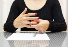 Woman Finalizing Divorce by Taking Ring Off